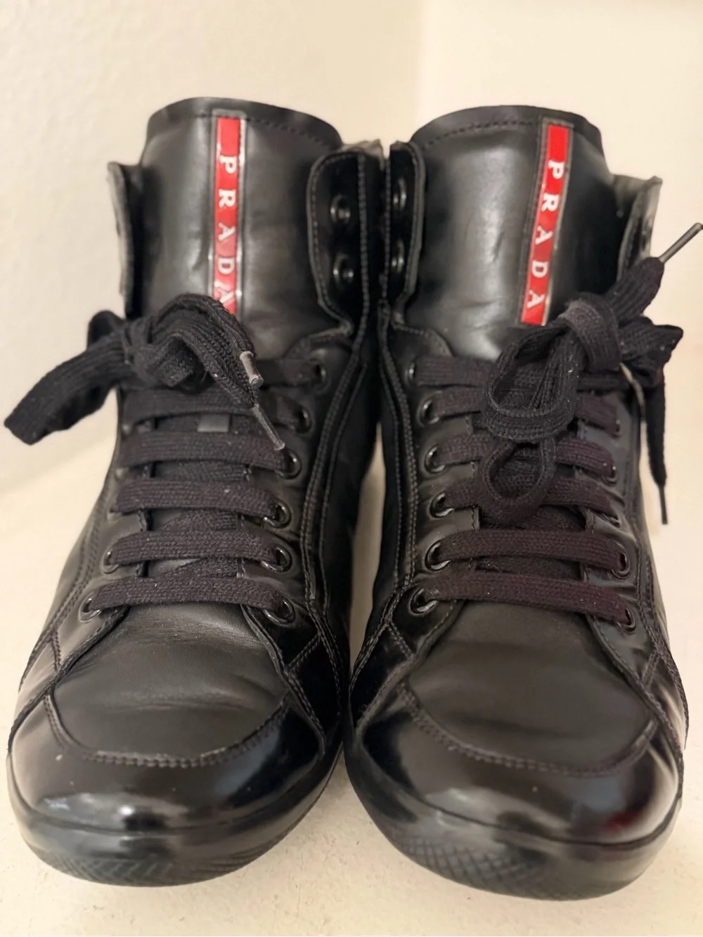Authentic Prada Black High-Top Leather Sneakers with Red Logo